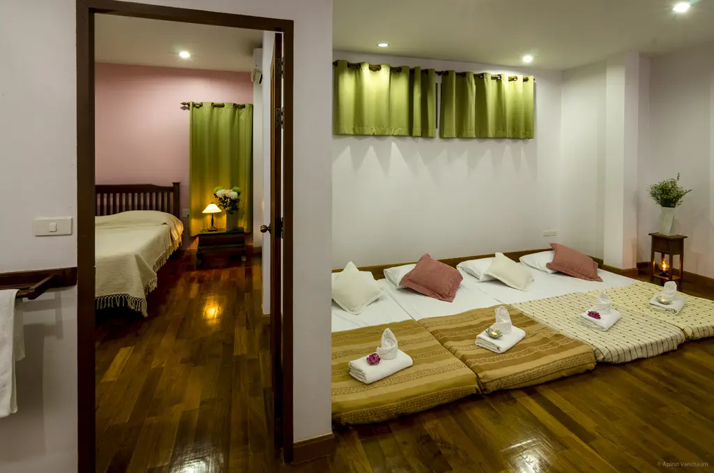 Ruam Mitr: room with mattresses made up on the floor and a doorway into the bedroom
