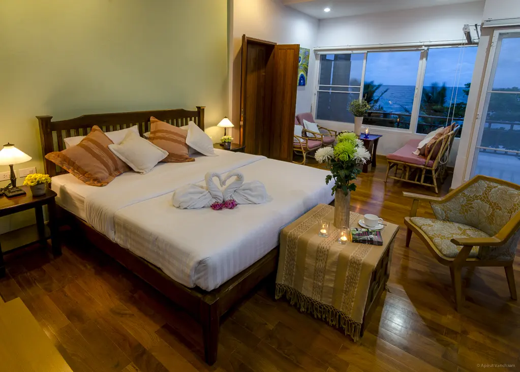 Nah Talay bedroom with double bed and a seating area with sea view