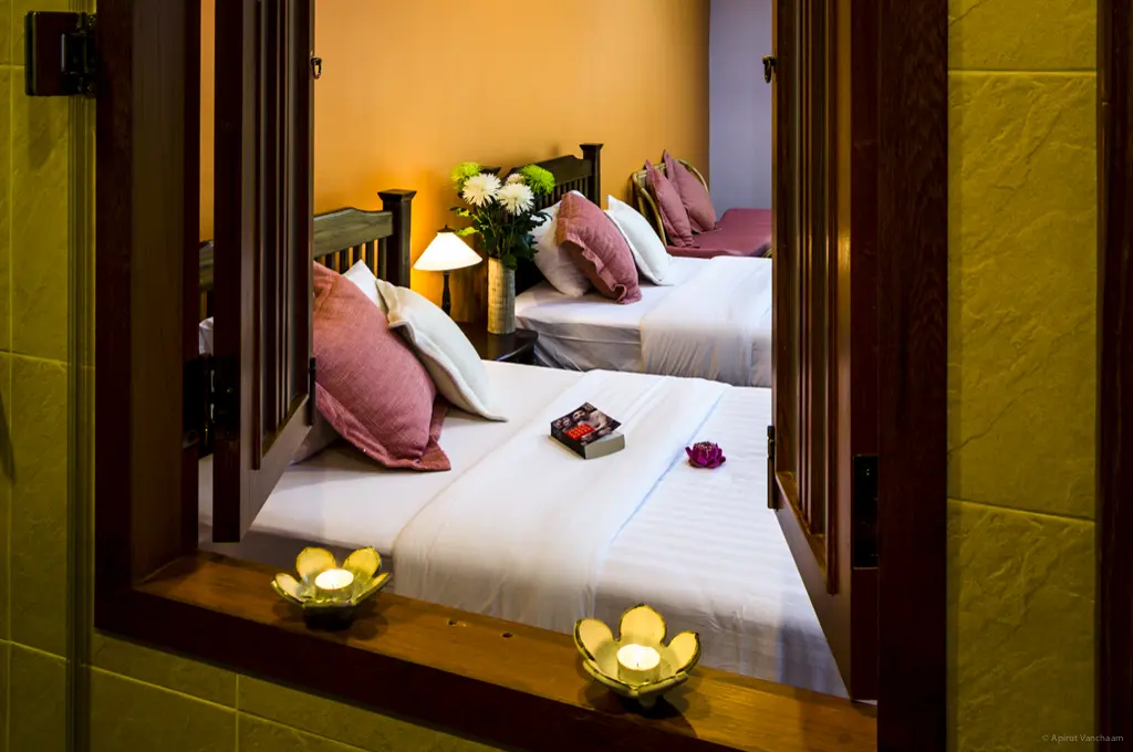 Chom Suan bedroom seen through the window opening from outside